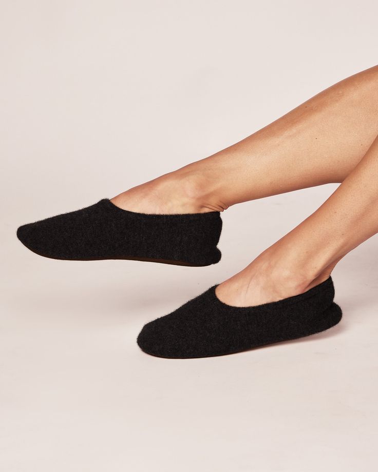 Step into a world of relaxation with our Cashmere Slippers. Made from Grade A 100% pure cashmere, these slippers cocoon your feet with unrivaled softness. Sink your toes into the plush texture and experience instant warmth and comfort. The meticulous craftsmanship ensures a snug and cozy fit making these slippers a delightful treat for your feet. Lining of insole is 100% cotton, comes with slipper bag. Comfortable Everyday Slippers With Leather Sole, Soft Slip-on Slippers For Relaxation, Slip-on Soft Slippers For Relaxation, Super Soft Slip-on Slippers For Lounging, Black Soft Slip-on Slippers, Super Soft Cozy Slippers For Relaxation, Comfortable Everyday Slippers With Rubber Sole, Super Soft Black Indoor Slippers, Cozy Super Soft Black Slippers