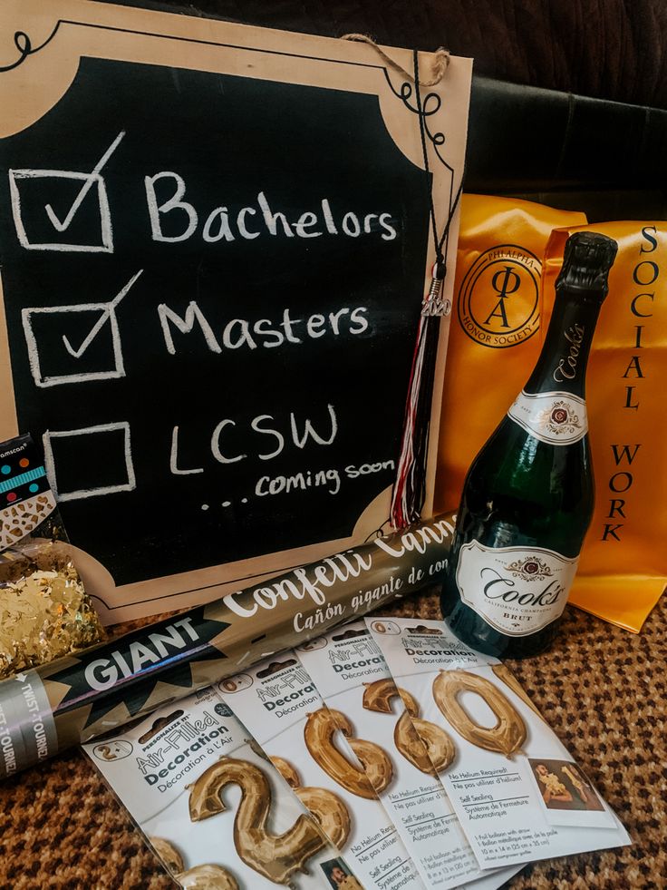 some food and wine are sitting on a table next to a chalkboard with the words bachelors masters