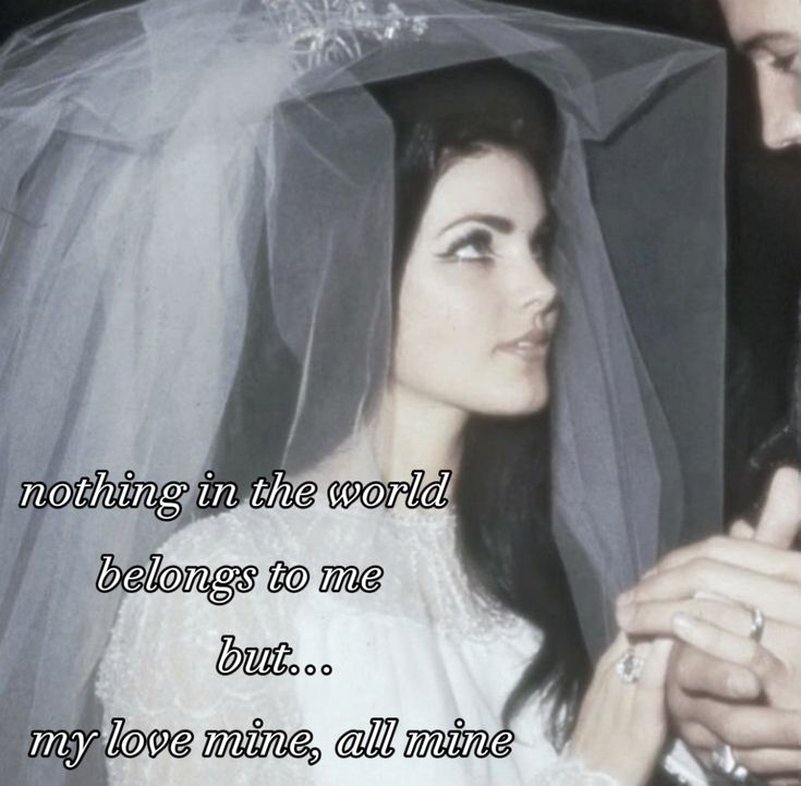 a man and woman standing next to each other in front of a wedding veil with the words, nothing in the world belongs to me but my love mine all mine