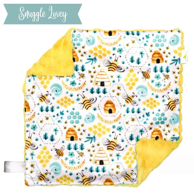 a yellow and white blanket with bees on it, next to the words snuggle layer