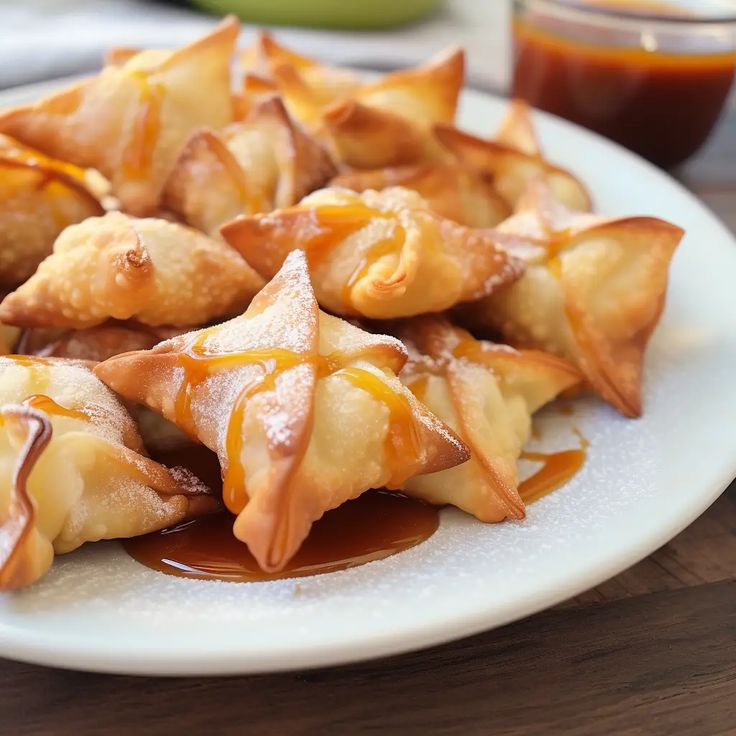 some food is sitting on a plate with sauce and ketchup in the background