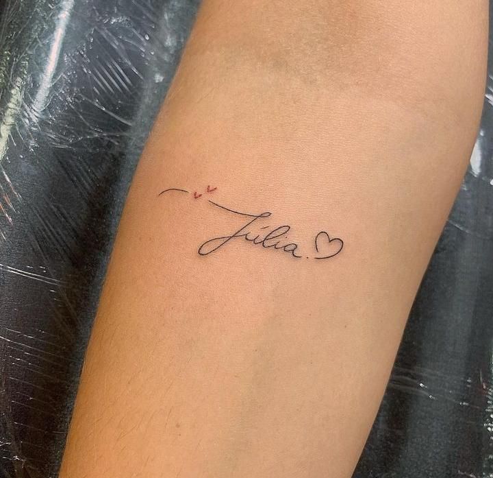 a tattoo with the word julia written in cursive writing on it's arm