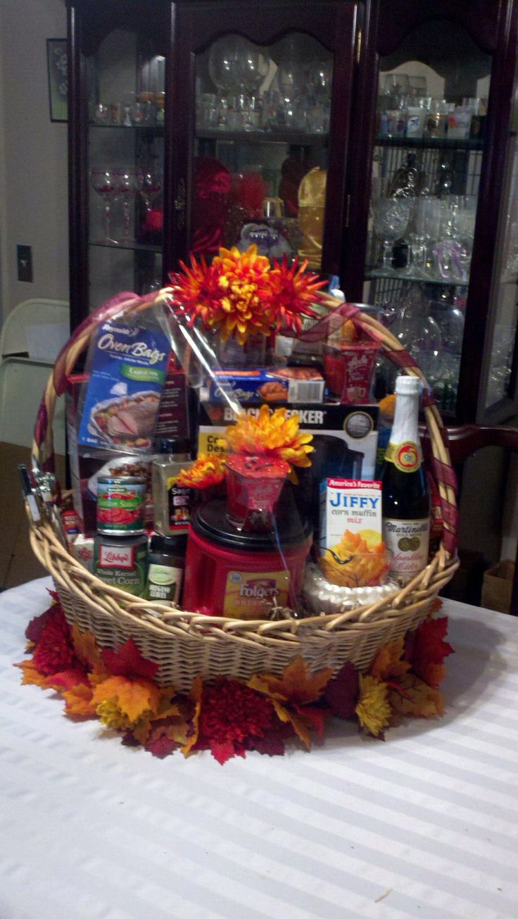 a basket filled with alcohol and snacks on top of a table