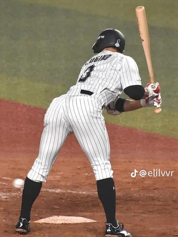 a baseball player holding a bat on top of a field