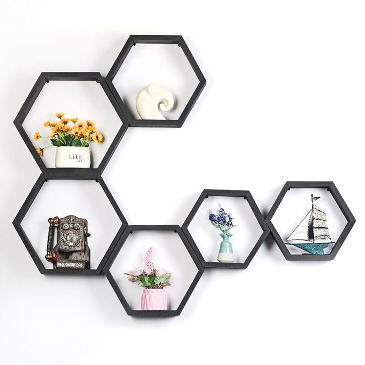 four hexagonal shelves with various items on them in the shape of hexagons