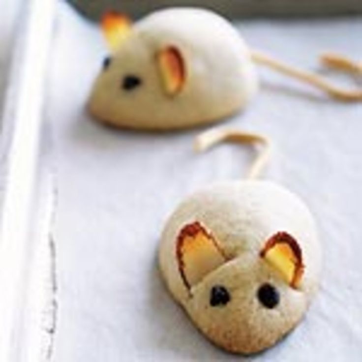 two cookies shaped like mice sitting on top of a table