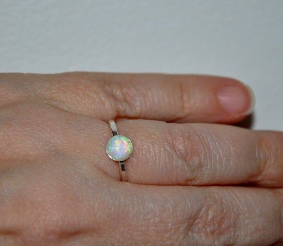 Shop Opal Stacking Ring Sterling Silver, Blue Opal Ring, White Opal Ring, Promise Ring, Size 6, 6.5, 7 Opal Jewelry Opal ring will bring a perfect touch of flair and splash of magnificent color to your outfit! Opal is an ideal gift as the birthstone for October. Your order will arrive in a nice box ready to be given. I made this elegant opal ring from: -925 Sterling silver band with a bezel - Lab created 6mm opal cabochon white or blue- please select a color you prefer Arrays of different colors Handmade Opal Ring With Round Stone For Gift, Handmade Opal Ring With Round Stone As Gift, Handmade Minimalist Round Opal Ring, Handmade Adjustable Opal Ring, Adjustable Opal Ring With Round Stone For Gift, Nickel-free Opal Promise Ring, Opal Ring Silver, Opal Stacking Ring, Blue Opal Ring