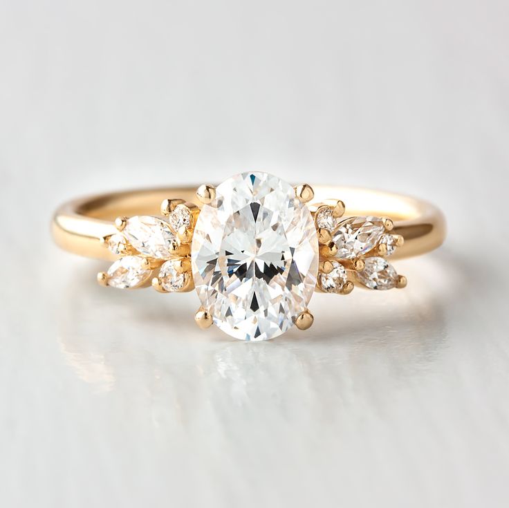 an oval cut engagement ring with three pear shaped diamonds