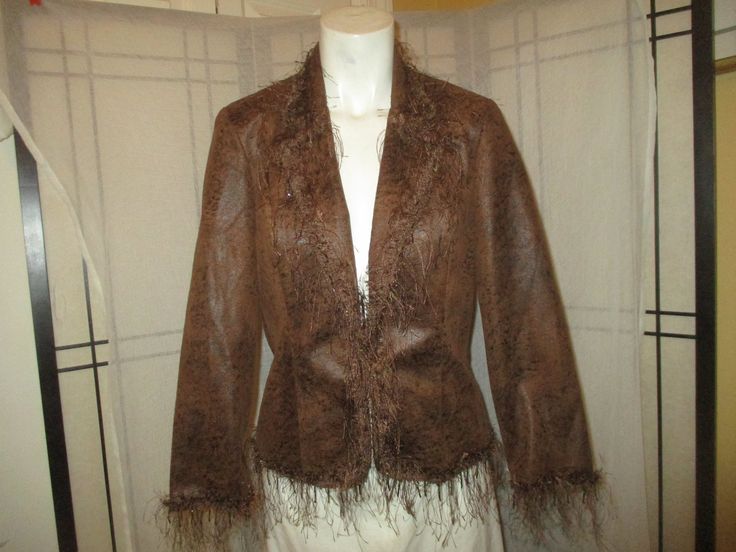 Fabulous fringed fun Joseph Ribkoff faux leather jacket @ 1990's. The fabric is 100% polyester. Polyester lining. Hand wash. Hang to dry. Shades of brown with an abstract animal print.  The fringed trim has braided trim and strands of beads. Single button and loop closure. Shoulder pads. Size 4. It measures 22" long. 15 1/4" across the top of the shoulders. 23" sleeves. Laying flat seam to seam it's 17" across under the arms, 15 1/2" at the waist. Like new condition. I ship same or next business Fitted Fringe Outerwear For Winter, Brown Fringe Outerwear For Winter, Brown Fringe Outerwear For Spring, Fringed Jacket, Abstract Animal Print, Fringe Leather Jacket, Flat Seam, Vintage Belt Buckles, Hat Man