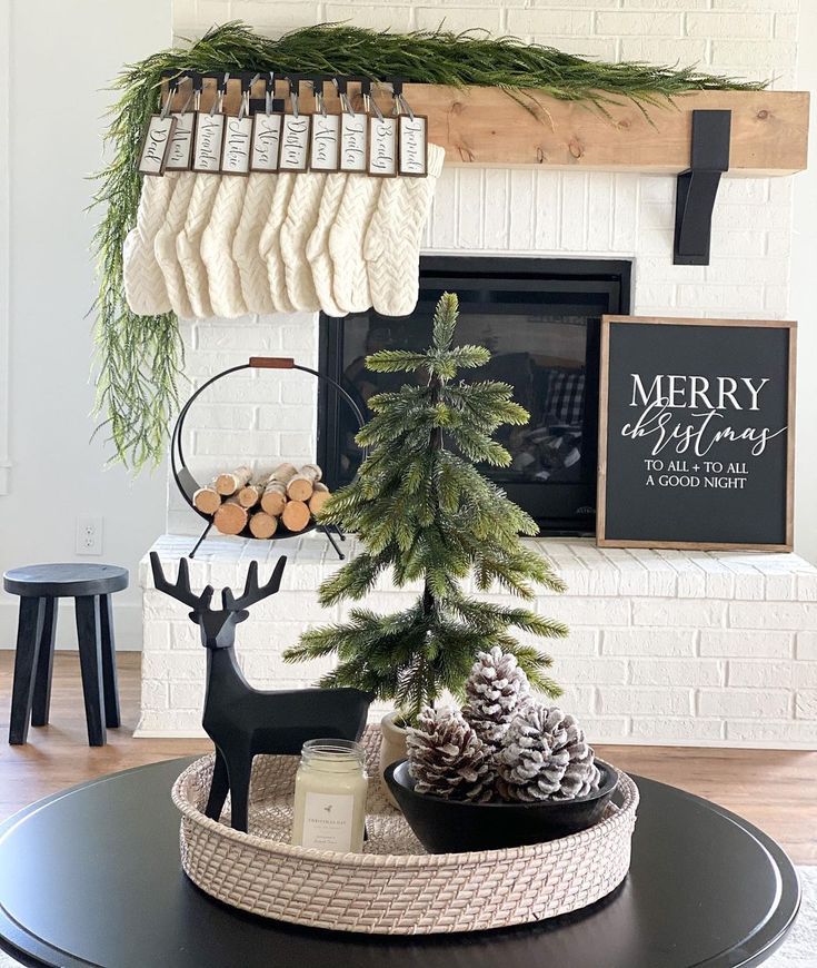 a christmas tree in a basket on top of a coffee table next to a fireplace