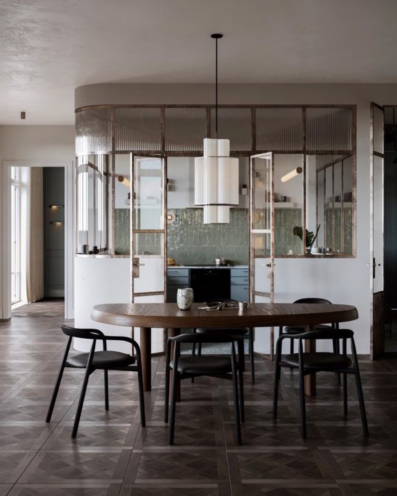 a dining room table and chairs in front of an open kitchen area with sliding glass doors