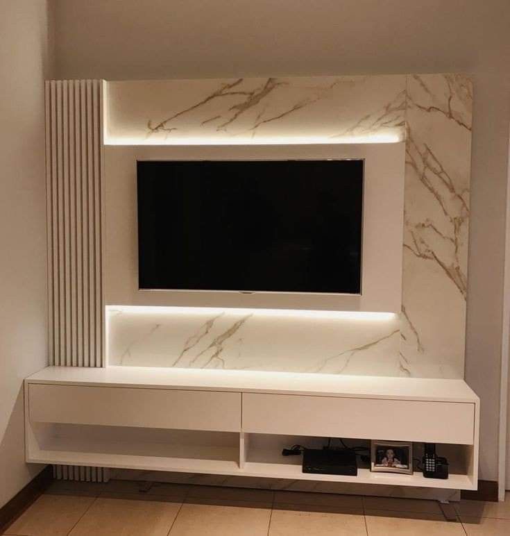 an entertainment center with a flat screen tv mounted on the wall