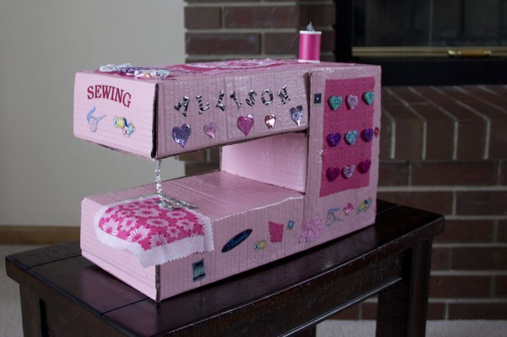 a pink sewing machine sitting on top of a table next to a brick fire place