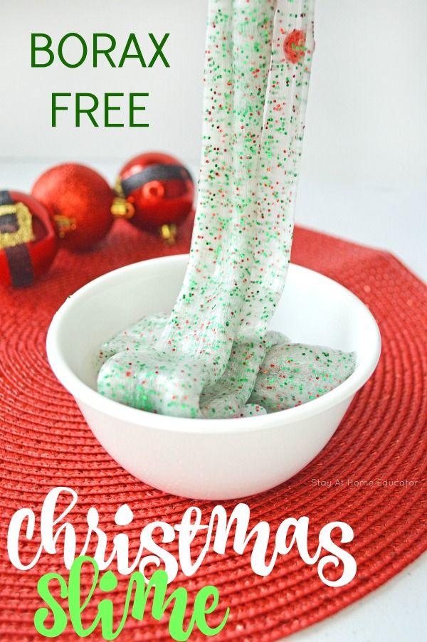 a bowl filled with green christmas slime next to ornaments and a red place mat