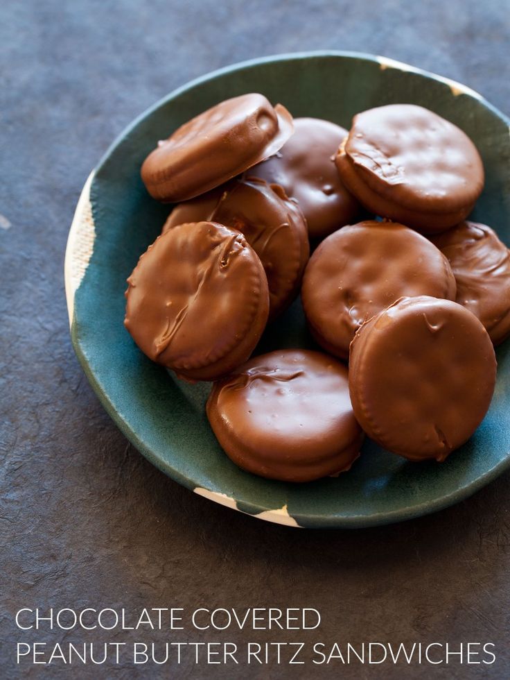 chocolate covered cookies in a green bowl on a table