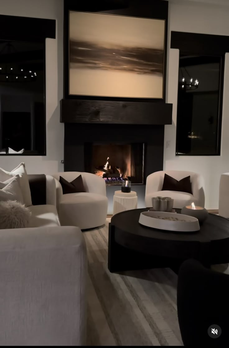 a living room filled with furniture and a fire place in the middle of the room