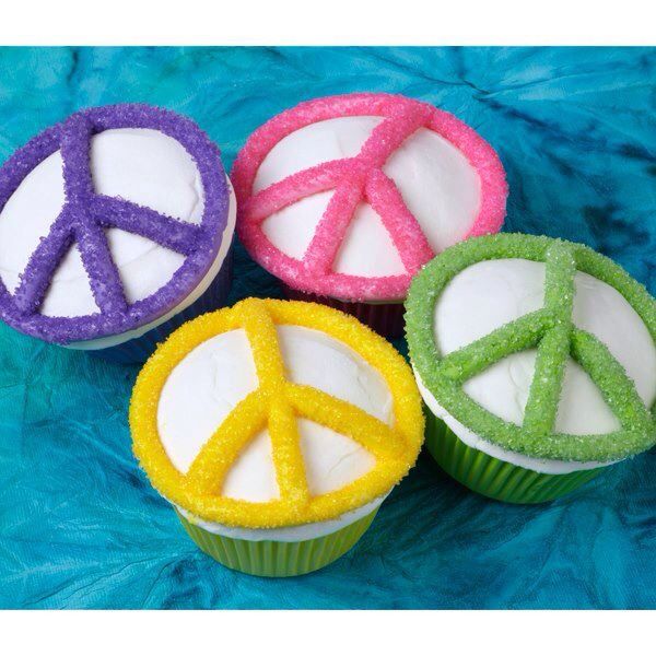 four cupcakes with peace signs on them