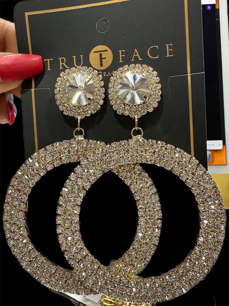 Add some sparkle and shine to your look with these statement rhinestone stud earrings. Crafted with shining, sparkling rhinestones set in a modern brushed metal setting, they are the perfect accessory to take any wardrobe up a notch. These earrings feature a secure push back closure and are lightweight and comfortable to wear. They're sure to draw compliments and attention any time you step out of the house. Measurements: L 4.13 inches W 2.95 inches Round Metal Crystal Earrings For Party, Metal Crystal Earrings With Bling, Party Crystal Earrings With Rhinestones, Trendy Sparkling Stones Hoop Earrings For Party, Trendy Hoop Earrings With Sparkling Stones For Party, Trendy Silver Crystal Earrings With Rhinestones, Trendy Silver Bling Earrings, Dazzling Crystal Earrings With Bling, Glamorous Cubic Zirconia Crystal Earrings