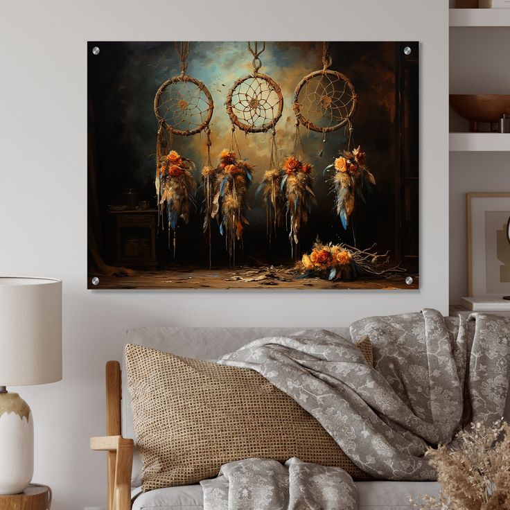 a living room scene with focus on the couch and wall hanging above it is an image of dream catchers