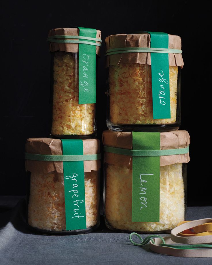 four jars filled with food sitting on top of a table