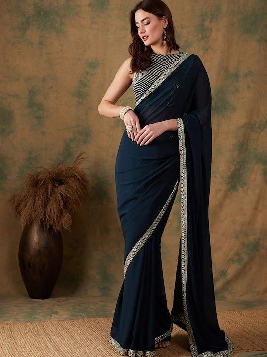 Blue sareeSolid saree with embroidered borderHas Sequinned detailThe saree comes with an unstitched blouse pieceThe blouse worn by the model might be for modelling purpose only. Check the image of the blouse piece to understand how the actual blouse piece looks like. Saree Ideas For Graduation Day, Falling Sarees, Sarees For Convocation Ceremony, Graduation Day Saree Ideas, Georgette Saree Blouse Piece With Embroidered Border, Georgette Blouse Piece With Embroidered Border For Saree, Dark Blue Saree For Farewell, Blue Georgette Saree With Embroidered Border, Navratri Saree Blouse With Embroidered Border