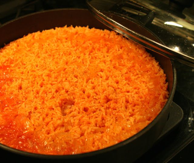 a pan filled with cheese covered food sitting on top of a stove next to an oven