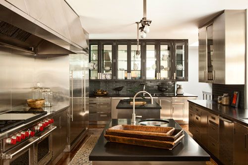 a modern kitchen with stainless steel appliances and black counter tops is pictured in this image