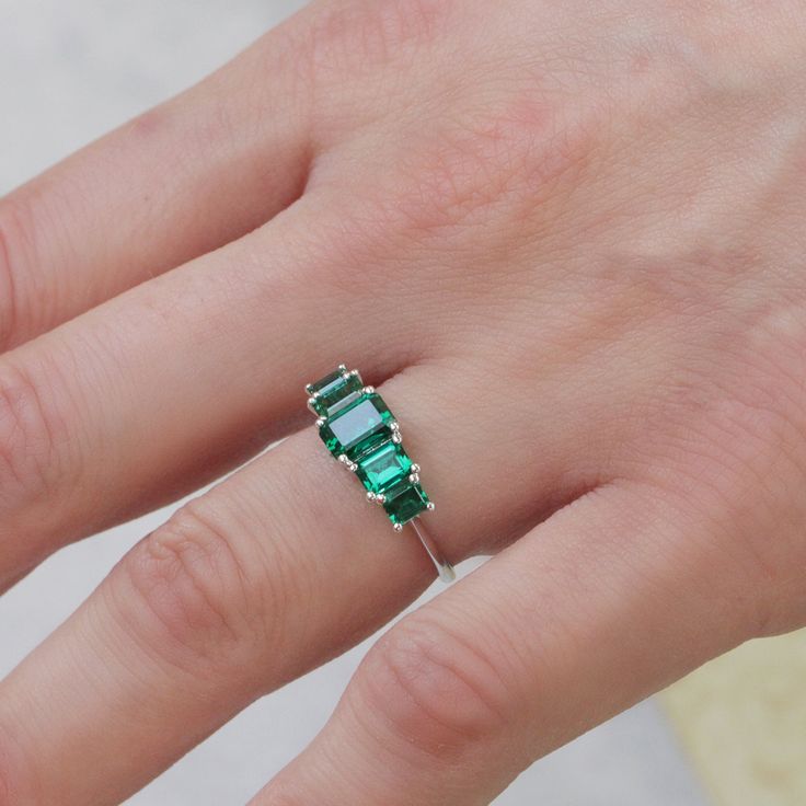 Spectacular. Stunning. Unforgettable. In our new Alexandrina ring we created a goldsmith masterpiece unlike anything else. Five large and deep-green emeralds are elevated above the ring with an elegant bridge decorated with our signature sign, forming an architectural perfection on your finger. It's not just a bling, the skilled craftsmanship and unique design turn the Alexandrina ring into a true heirloom that will never go out of style and will be passed through generations. **Due to the natur 14k White Gold Green Emerald Ring, Fine Jewelry Emerald Ring In 14k White Gold, Gift Emerald Multi-stone Ring In White Gold, White Gold Multi-stone Emerald Ring Fine Jewelry, 14k White Gold Emerald Ring, May Birthstone, Pendant Rings, Girls Earrings, Natural Emerald, Bracelet Collection