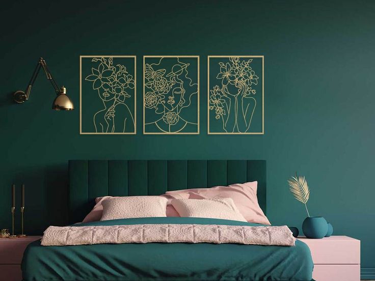 a bedroom with green walls and two paintings on the wall