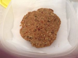 a cookie sitting in a plastic container on top of a white tablecloth covered surface