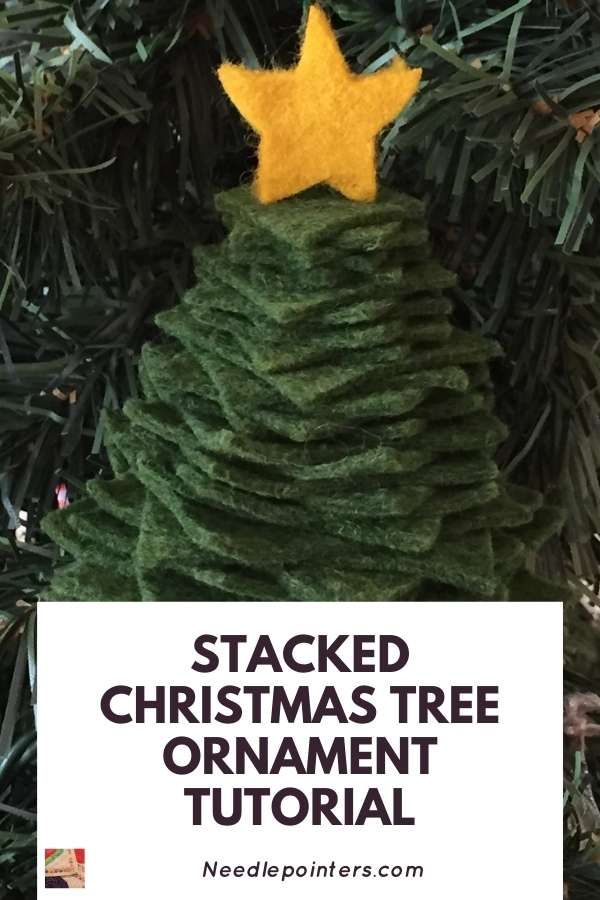 a christmas tree ornament made out of yarn with the words stacked christmas tree ornament