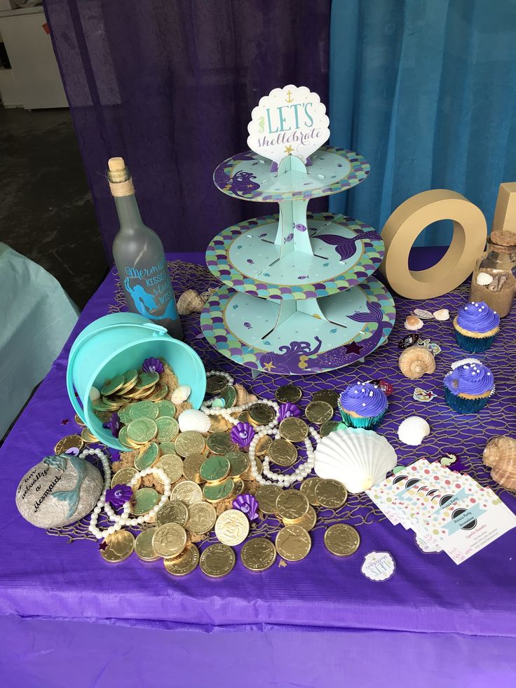 a table topped with lots of different types of coins and confection on top of it