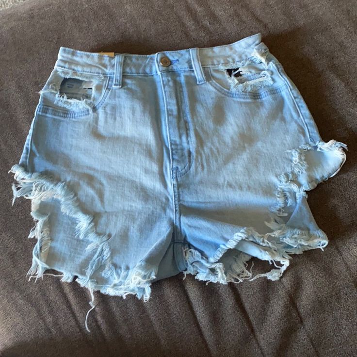 Brand New Run Very Small Blue Stretch Cutoff Jean Shorts, Light Blue Ripped Mid-rise Bottoms, Mid-rise Ripped Light Blue Bottoms, Ripped Light Blue Mid-rise Bottoms, Light Blue Ripped Cotton Bottoms, Blue Ripped Short Bottoms, Ripped Blue Short Bottoms, High Waist Ripped Blue Bottoms, Blue Ripped High Waist Shorts