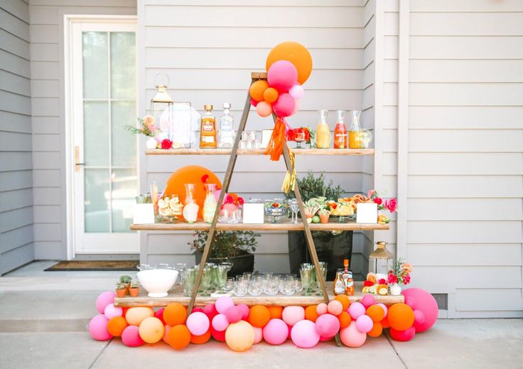 an outdoor bar set up with balloons and confetti