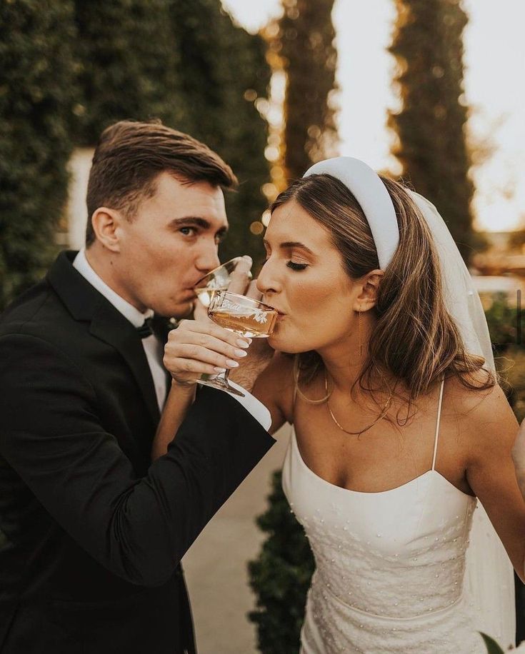 the bride and groom are drinking wine together