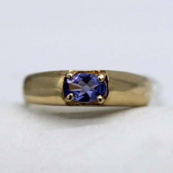 ⚓14K Gold  Sideways Oval Tanzanite Ring (Size 6.5) Solid 14K gold, stamped 14K. Not filled or plated. In excellent condition! We sell the highest quality vintage and pre-owned items. Free domestic shipping always! On its way to you in 1 business day.  30 day return policy!  ⚓The Details Size 6.5 1 Tanzanite approximately 0.288 ct wt 5.21 mm band width at crown of ring 3.31 mm band width at bottom 4.1 grams ⚓Who We Are  We are a small, family-owned business in Plymouth, MA. Located in the heart of Main Street, Main Street Jewelry Co.'s mission is to find one-of-a-kind, unique pieces. Vintage, antiques, and rare finds are our specialty, of course other than our brand new Italian silver chains with a price that can't be beat. We thank you for supporting small businesses everywhere and checkin Classic Domed Sapphire Ring Gift, Classic Domed Sapphire Ring, Timeless Gold Oval Amethyst Ring, Timeless Gold Amethyst Ring For Anniversary, Timeless Oval Gold Amethyst Ring, Vintage Oval Sapphire Birthstone Ring, Vintage Oval Sapphire Ring As Birthstone, Vintage 14k Gold Oval Sapphire Ring, Vintage Oval Sapphire Ring In 14k Gold