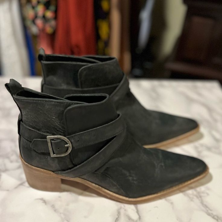 Free People Back Loop Ankle Boots In Black Say Hello To The Perfect, Most Versatile Boot. The Ankle Height Makes This Style Easily Transition From Day To Night. Wear Them With Your Favorite Skinny Jeans And Tee For A More Laid Back Look, Or Pair Them With Your Favorite Mini Dress And Jacket For A Night Out On The Town.So Cool Ankle Boots Featured In A Pull-On Style And Distressed Leather With An Adjustable Buckle Strap, Heel Loops For An Easy On And Off, And An Eye-Catching Block Heel. Lined Foo Chic Ankle-high Boots With Heel Loop, Designer Ankle Strap Boots For Fall, Designer Ankle Moto Boots, Black Suede-lined Ankle Heeled Boots, Black Suede Lined Ankle Heeled Boots, Chic Suede Booties With Flat Heel, Chic Moto Boots With Pointed Toe And Leather Sole, Chic Flat Heel Suede Booties, Black Pointed Toe Heeled Boots With Suede Lining