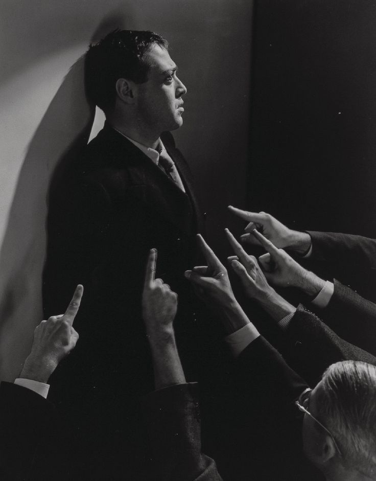 black and white photograph of five people reaching out their hands