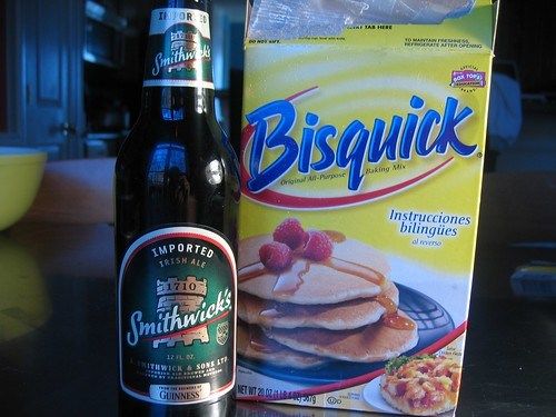 a bottle of beer next to a package of biscuits