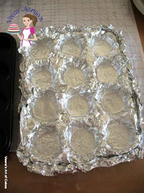 an uncooked pan filled with cookies on top of a counter next to a baking sheet