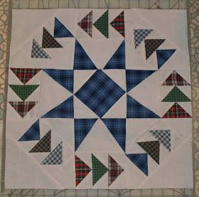 a quilted table topper with blue, green and red triangles in the center