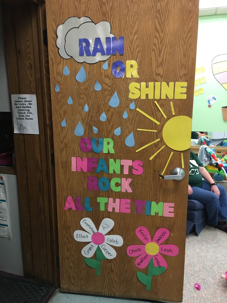 a door with rain written on it and flowers painted on the side, in front of a classroom