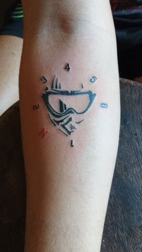 a man with a tattoo on his leg that has an image of a boat in the water