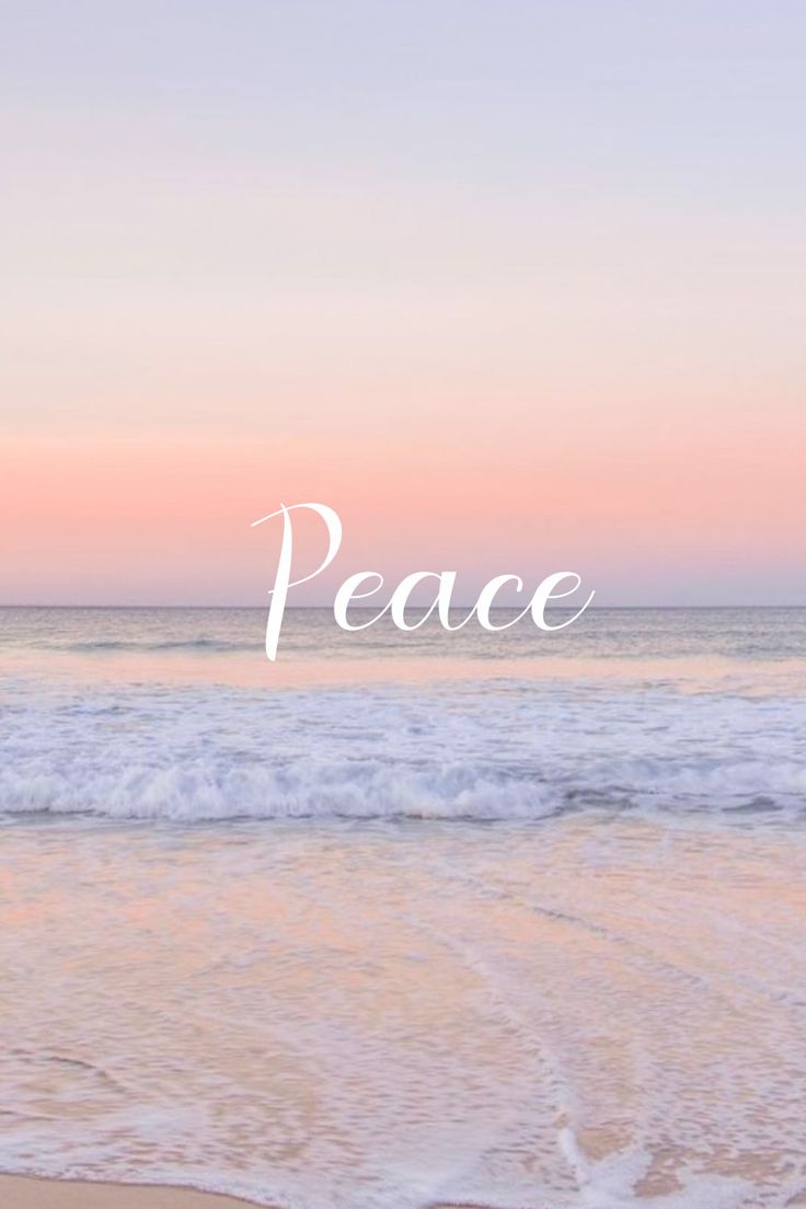 the word peace is written in white over an ocean beach