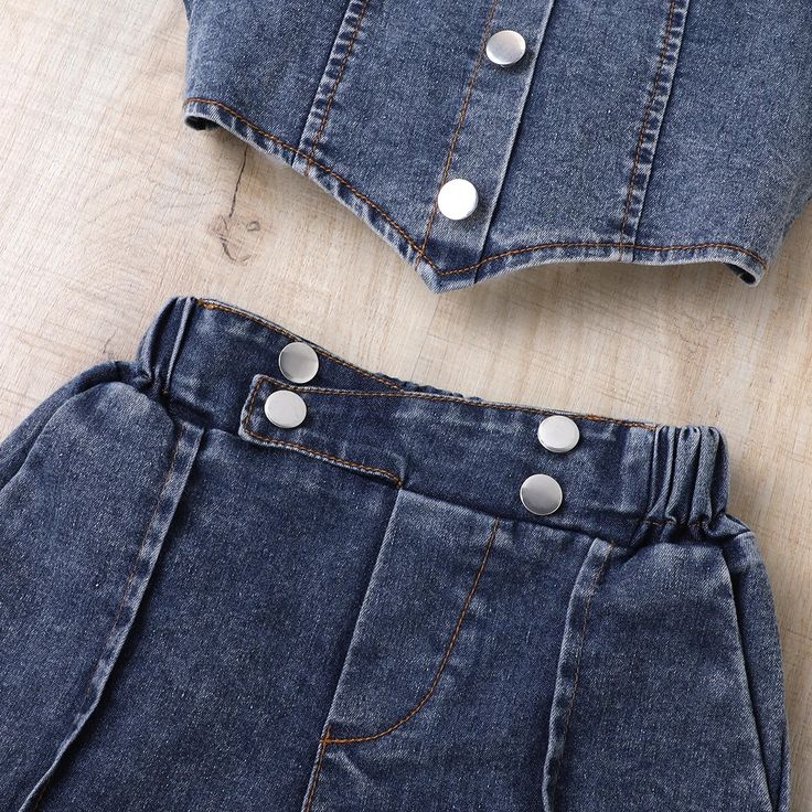 Embrace stylish and sunny adventures with our Rustic Denim Crop Top and Shorts Set. Perfect for picnics and cowgirl escapades, this duo exudes fresh and pretty spring vibes. Crafted from soft and lightweight fabric, it offers all-day comfort without weighing your little girl down. The versatile pieces can be easily paired with her other favorites, making it a perfect choice for casual outings, vacations, playdates, and more. This set includes a puff sleeve denim top with button details and match Toddler Summer Outfits, Denim Suit, Top And Shorts Set, Toddler Summer, Denim Crop Top, Crop Top And Shorts, Spring Vibes, Dressy Outfits, Casual Sets