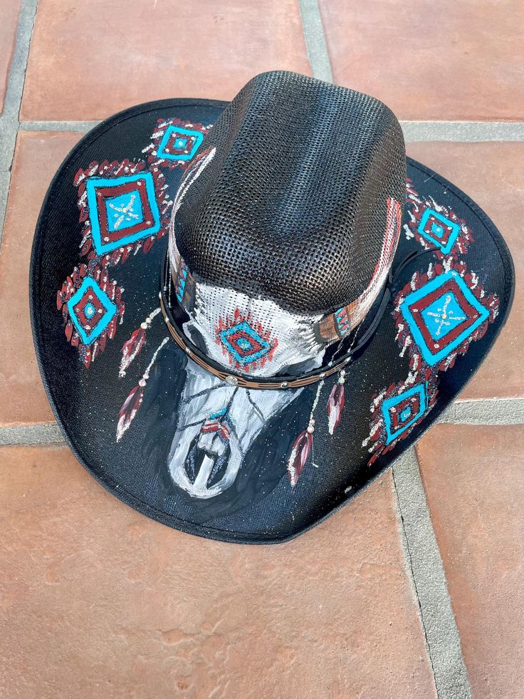 Hand painted vinyl cowboy hat with southwest-style and skull. Flexible fit. Includes rhinestones and glitter. One of a kind. Hand Painted Adjustable Hat Bands For Rodeo, Hand Painted Adjustable Hat Band For Rodeo, Adjustable Hand Painted Hat Band For Rodeo, Hand Painted Western Hat Bands For Rodeo, Hand Painted Western Hat Bands For Festival, Western Hand Painted Hats For Country Events, Hand Painted Adjustable Western Hat, Adjustable Hand Painted Western Hat, Western Style Hand Painted Hat Bands For Country Events