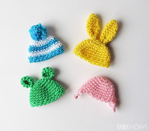 three crocheted hats are shown on a white surface