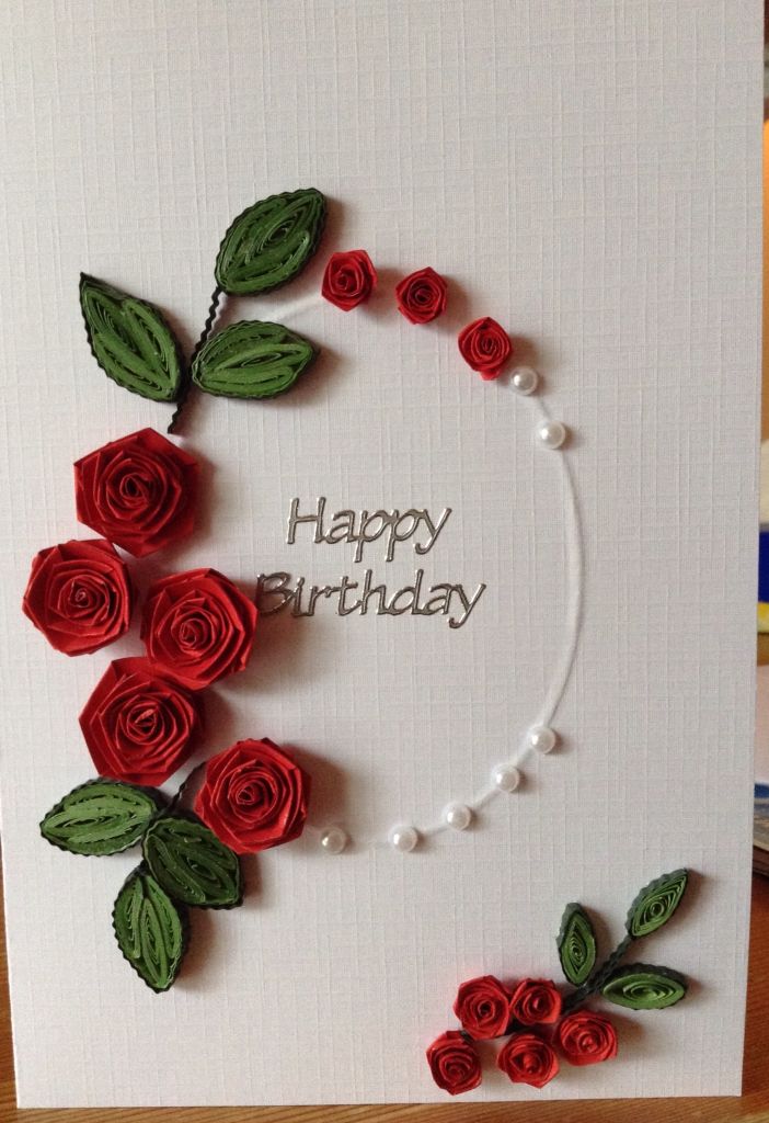 a handmade birthday card with red roses and pearls