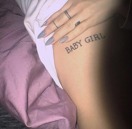 a close up of a person with a tattoo on their arm and the words baby girl