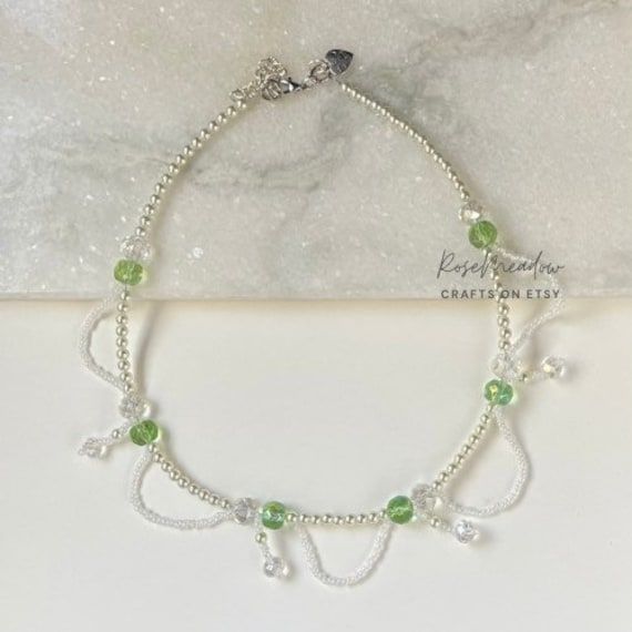 "Wear this necklace to a picnic or a nice stroll through a meadow 🌿 ✿ Made with faux pearls, glass crystal beads, seed beads, and metal accents ✿ Pearly white, green, green, and silver ✿ 17.5\" plus 1.8\" of extension chain" Adjustable Green Crystal Necklace With Beaded Chain, Handmade Jewlery, Bracelets Design, Green And Silver, Bead Charms Diy, Kawaii Jewelry, Beads Bracelet Design, Prom Jewelry, Butterfly Bracelet